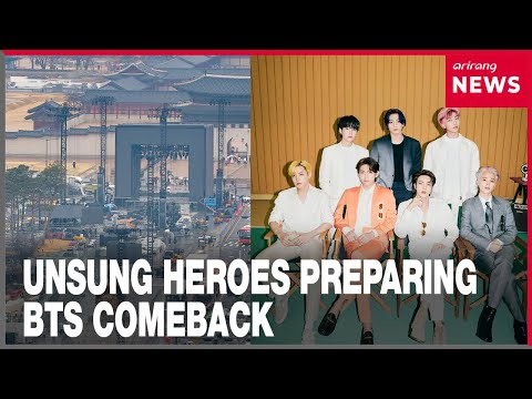 Telecom technicians setting up a temporary mobile cell site in preparation for a large concert.