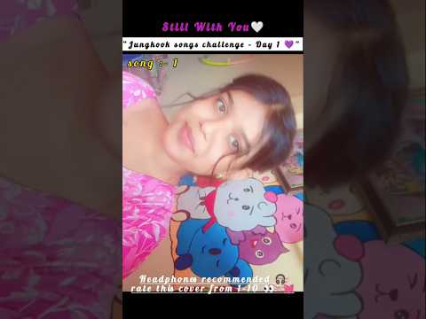 A female vocalist passionately singing into a microphone, with a purple-toned background and a subtle spotlight effect, mirroring the emotional atmosphere of Jungkook's 'Still With You'.