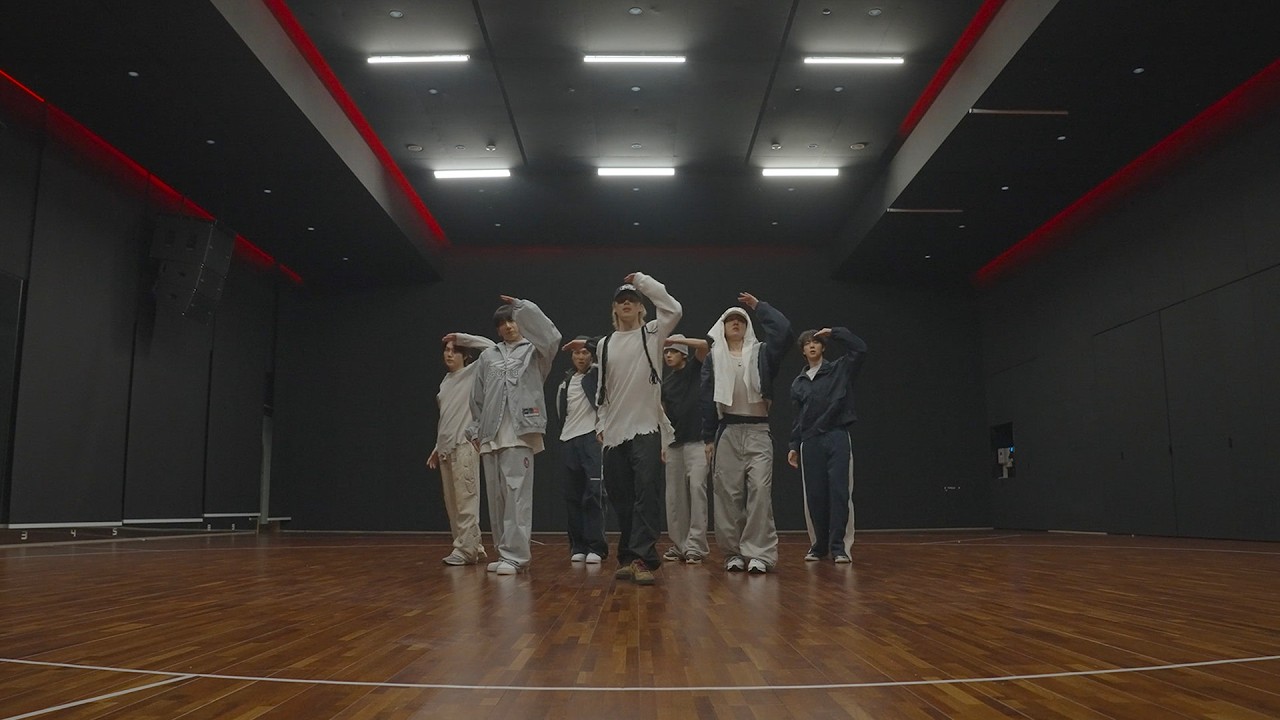 BTS members performing 'SWIM' dance practice in a studio.