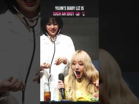 IVE's Liz and Yujin interacting at a fanmeeting, with Liz showing a clumsy but adorable moment