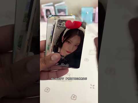 K-Pop photocards and merchandise being unboxed, featuring items from TWICE, Stray Kids, and IVE.