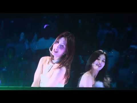 TWICE members performing 'Dance The Night Away' on stage with vibrant energy.