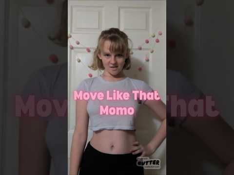 Dancer in a black outfit performing 'Move Like That' in a public setting.